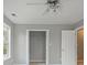 Cozy bedroom featuring neutral walls, a double closet, and a ceiling fan for added comfort at 1754 Heights Nw Cir # 11, Kennesaw, GA 30152
