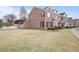 Traditional brick exterior featuring manicured lawn with mature landscaping at 1754 Heights Nw Cir # 11, Kennesaw, GA 30152