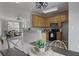 Open kitchen with wood cabinets and modern appliances provides a seamless transition to living spaces at 1754 Heights Nw Cir # 11, Kennesaw, GA 30152