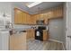 Well-lit kitchen with wood cabinets, granite countertops, stainless steel appliances, and a stylish gas range at 1754 Heights Nw Cir # 11, Kennesaw, GA 30152