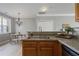 Cozy kitchen view showcasing a sink with wood cabinets with a dining area and decorative chandelier beyond at 1754 Heights Nw Cir # 11, Kennesaw, GA 30152