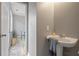 Classic powder room featuring a pedestal sink with a decorative mirror and neutral color palette at 1754 Heights Nw Cir # 11, Kennesaw, GA 30152