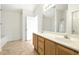 Bright bathroom featuring a double sink vanity, mirror, and separate shower area at 2572 Avery Park Cir, Doraville, GA 30360