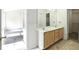 Bright bathroom with double sinks, a large mirror, and tile flooring at 2572 Avery Park Cir, Doraville, GA 30360