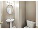 Compact half-bathroom with a pedestal sink and a toilet at 2572 Avery Park Cir, Doraville, GA 30360