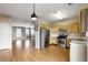 Open concept kitchen with stainless steel appliances and light wood cabinets adjacent to a spacious living area at 2572 Avery Park Cir, Doraville, GA 30360