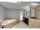 Primary bathroom with a soaking tub, walk-in shower, and tiled floor at 5130 N Peachtree Rd, Dunwoody, GA 30338
