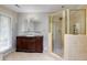Bathroom featuring a walk-in shower, and a wooden vanity with a sink at 5130 N Peachtree Rd, Dunwoody, GA 30338