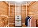 Walk-in closet with custom wood paneling, storage shelves, and hanging rods at 5130 N Peachtree Rd, Dunwoody, GA 30338