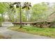 Ranch-style home featuring a brick facade, well-manicured lawn, and a long driveway at 5130 N Peachtree Rd, Dunwoody, GA 30338