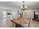 Open kitchen and dining area with white cabinets, an island, and stainless steel appliances at 5130 N Peachtree Rd, Dunwoody, GA 30338