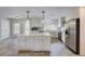 Modern kitchen featuring stainless steel appliances, granite countertops, and a central island at 5130 N Peachtree Rd, Dunwoody, GA 30338