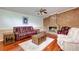 Comfortable living room with hardwood floors, a brick fireplace and a ceiling fan at 5130 N Peachtree Rd, Dunwoody, GA 30338