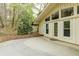 Attached patio of home with double french doors and brick border offers outdoor living space at 5130 N Peachtree Rd, Dunwoody, GA 30338