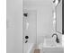 Modern bathroom featuring white marble tile and black fixtures, creating a clean and stylish aesthetic at 5496 Davis Dr, Austell, GA 30106