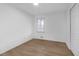 Bright bedroom with neutral walls, a window, and new hardwood floors, offering a serene retreat at 5496 Davis Dr, Austell, GA 30106