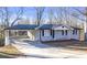 Street view of the home, featuring a covered carport and long driveway at 5496 Davis Dr, Austell, GA 30106