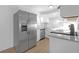 Kitchen featuring stainless steel appliances, granite countertops, and a stylish tile backsplash at 5496 Davis Dr, Austell, GA 30106