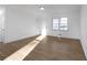 Living room features laminate flooring, a window, and a white interior door at 5496 Davis Dr, Austell, GA 30106
