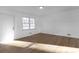 Bright living room with laminate flooring, a window, and a white front door at 5496 Davis Dr, Austell, GA 30106