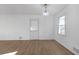 Living room with laminate floors, white walls, and modern light fixture at 5496 Davis Dr, Austell, GA 30106