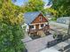 Stunning aerial view of a home with a brick driveway, landscaped yard, and a fire pit area at 1060 Mcdaniel Sw St, Atlanta, GA 30310
