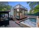 Stunning backyard with a pool, patio, outdoor kitchen, privacy landscaping, and a glass-enclosed building at 1060 Mcdaniel Sw St, Atlanta, GA 30310