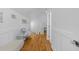 Hallway with wainscoting and hardwood floors leading to a home office at 1060 Mcdaniel Sw St, Atlanta, GA 30310