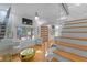 Bright living room with hardwood floors, modern lighting, and clear glass staircase panel at 1060 Mcdaniel Sw St, Atlanta, GA 30310