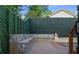 Stone patio with seating and fire pit by outdoor pool, surrounded by privacy hedge at 1060 Mcdaniel Sw St, Atlanta, GA 30310