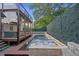 Backyard pool with jacuzzi, stone surround, privacy fence, and an outdoor living area at 1060 Mcdaniel Sw St, Atlanta, GA 30310