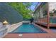 Backyard pool area with a spa, fire features, privacy landscaping, and a glass-enclosed building at 1060 Mcdaniel Sw St, Atlanta, GA 30310