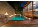 Backyard pool area featuring fire features, privacy landscaping, and a glass-enclosed sunroom at dusk at 1060 Mcdaniel Sw St, Atlanta, GA 30310