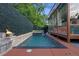 Backyard pool with attached spa, privacy wall, gas torches, and an outdoor living area at 1060 Mcdaniel Sw St, Atlanta, GA 30310