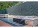 Backyard pool with integrated jacuzzi, privacy wall, and gas torches at 1060 Mcdaniel Sw St, Atlanta, GA 30310