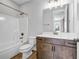 Bathroom with white countertop, dark wood cabinets, shower, and tub/shower combo at 267 Castleberry Station Sw Dr, Atlanta, GA 30313