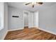 Bright bedroom with hardwood floors, a ceiling fan, and ample closet space, offering comfort and functionality at 267 Castleberry Station Sw Dr, Atlanta, GA 30313