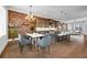 Open-concept kitchen and dining area features modern lighting, stainless appliances, and breakfast bar seating at 267 Castleberry Station Sw Dr, Atlanta, GA 30313