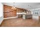 Open layout kitchen with exposed brick, granite island, stainless appliances, and a spacious dining area at 267 Castleberry Station Sw Dr, Atlanta, GA 30313