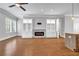 Open-concept living room with modern fireplace, built-ins, and hardwood floors for a cozy gathering space at 267 Castleberry Station Sw Dr, Atlanta, GA 30313