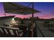 Inviting rooftop deck featuring comfortable seating, an umbrella, and expansive city views at sunset at 267 Castleberry Station Sw Dr, Atlanta, GA 30313