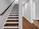 Bright staircase with dark wood treads and handrail leading to the upper level of the home at 267 Castleberry Station Sw Dr, Atlanta, GA 30313