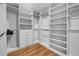 Large walk-in closet featuring wood floor and custom shelves, drawers, and closet rods at 267 Castleberry Station Sw Dr, Atlanta, GA 30313