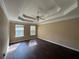 Spacious bedroom featuring hardwood floors, two windows for natural light, and a ceiling fan at 4302 Sorrells Dr, Powder Springs, GA 30127