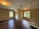 Bedroom featuring wood-look floors, angled ceiling, and two windows at 4302 Sorrells Dr, Powder Springs, GA 30127