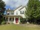 Charming two-story home with a welcoming front porch and a well-manicured lawn at 4302 Sorrells Dr, Powder Springs, GA 30127