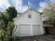 Two car garage with white doors and exterior lights provides plenty of space for parking and storage at 4302 Sorrells Dr, Powder Springs, GA 30127