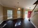 Inviting living room with dark wood floors, bright windows, and a red front door at 4302 Sorrells Dr, Powder Springs, GA 30127