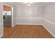 Well-lit dining area with wood floors and stainless steel refrigerator at 602 Abingdon Way, Atlanta, GA 30328