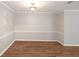 Dining room with wood-look flooring, trim work, and modern lighting at 602 Abingdon Way, Atlanta, GA 30328
